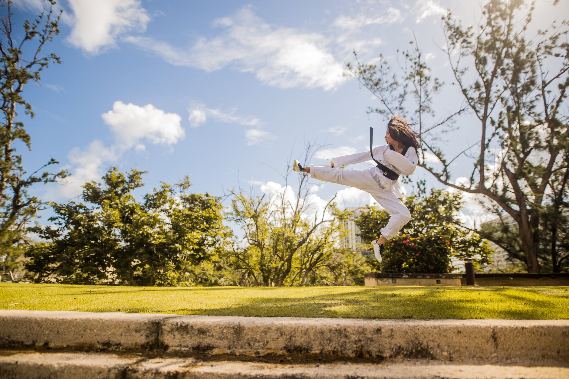 woman wearing white karati g under blue sky